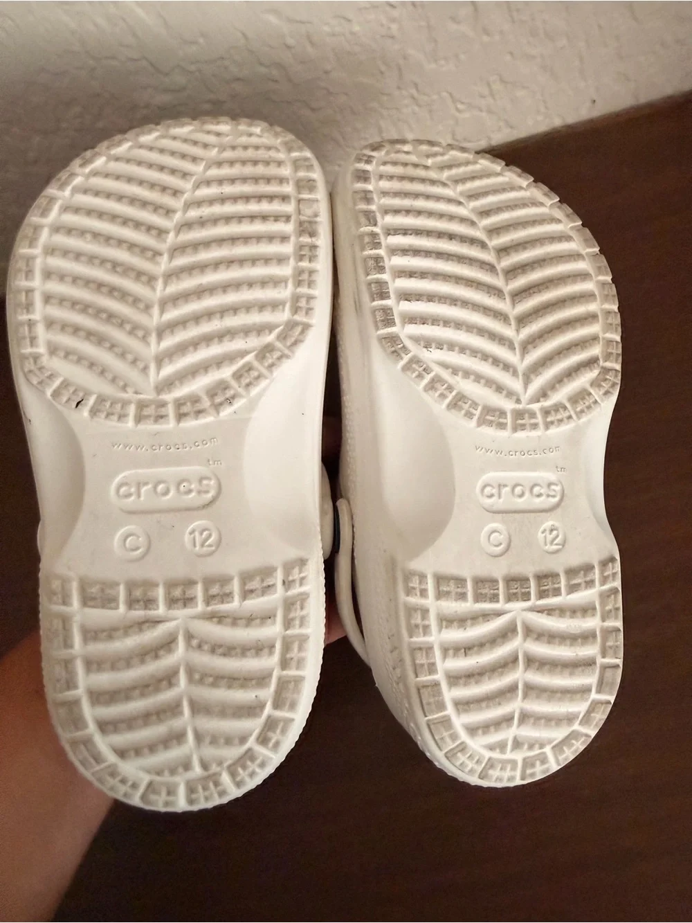 white Crocs Baya Lined Clogs featuring a cozy grey faux-fur lining. C-12